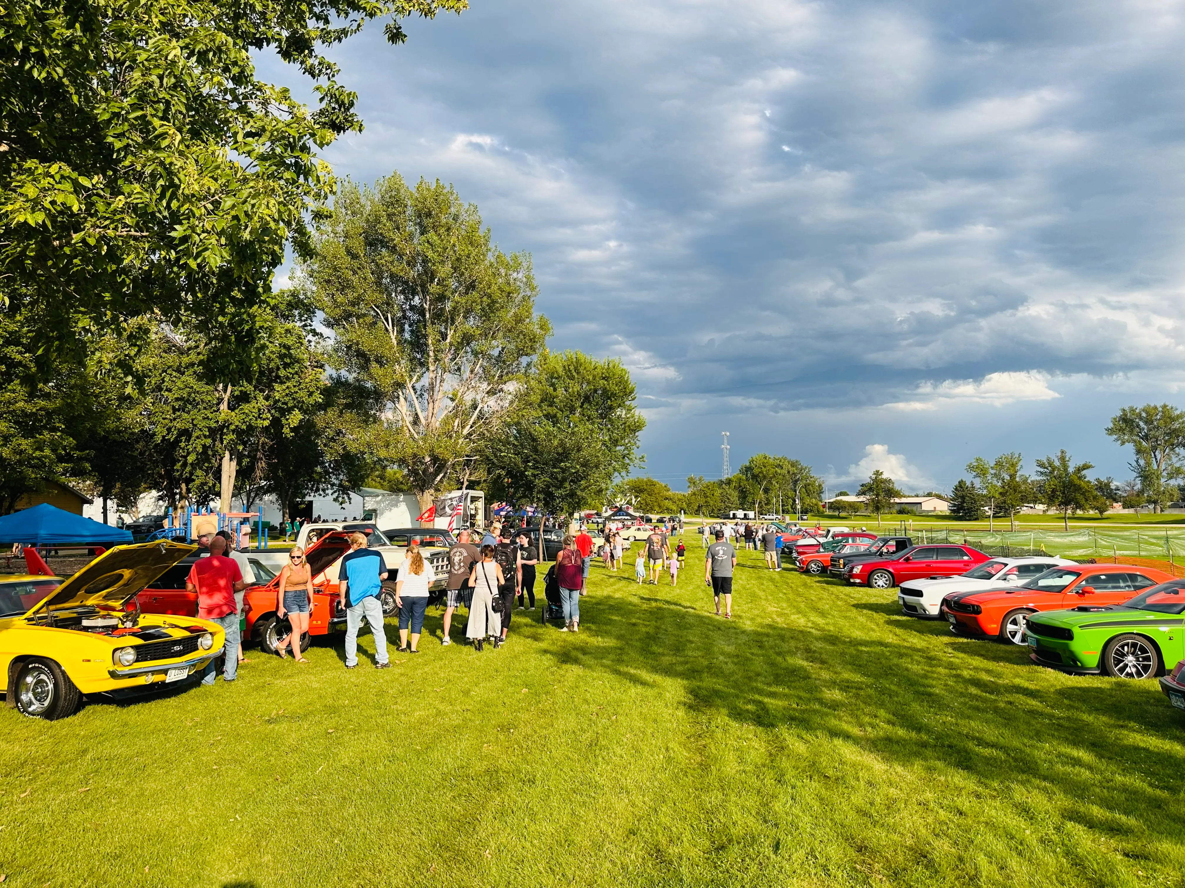 Blue OK Tire Store booth tent with staff and customers interacting